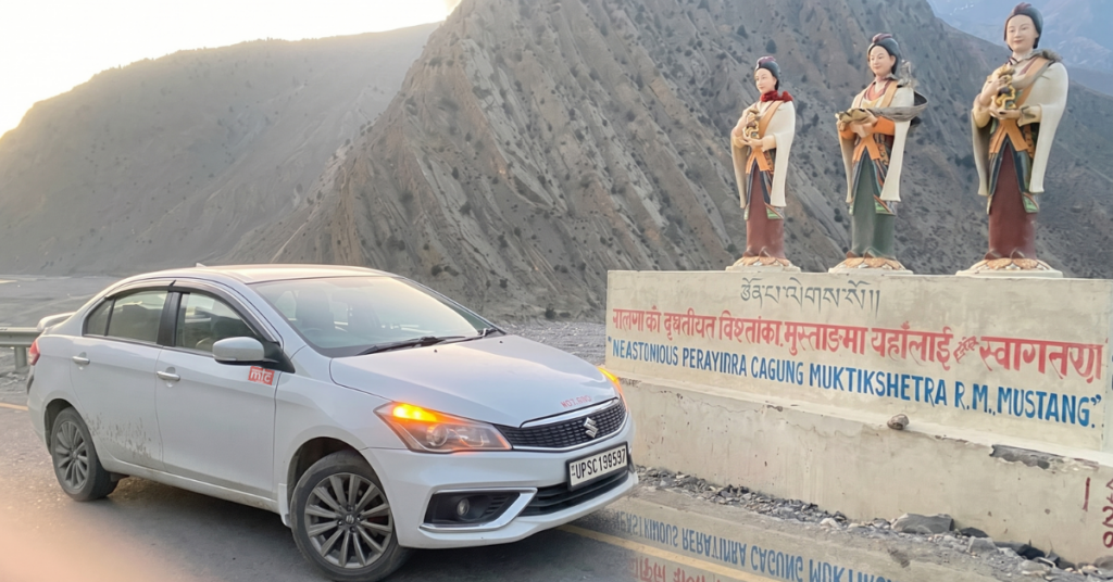 White Innova Crysta SUV driving on Himalayan highway route for Gorakhpur to Muktinath taxi trip